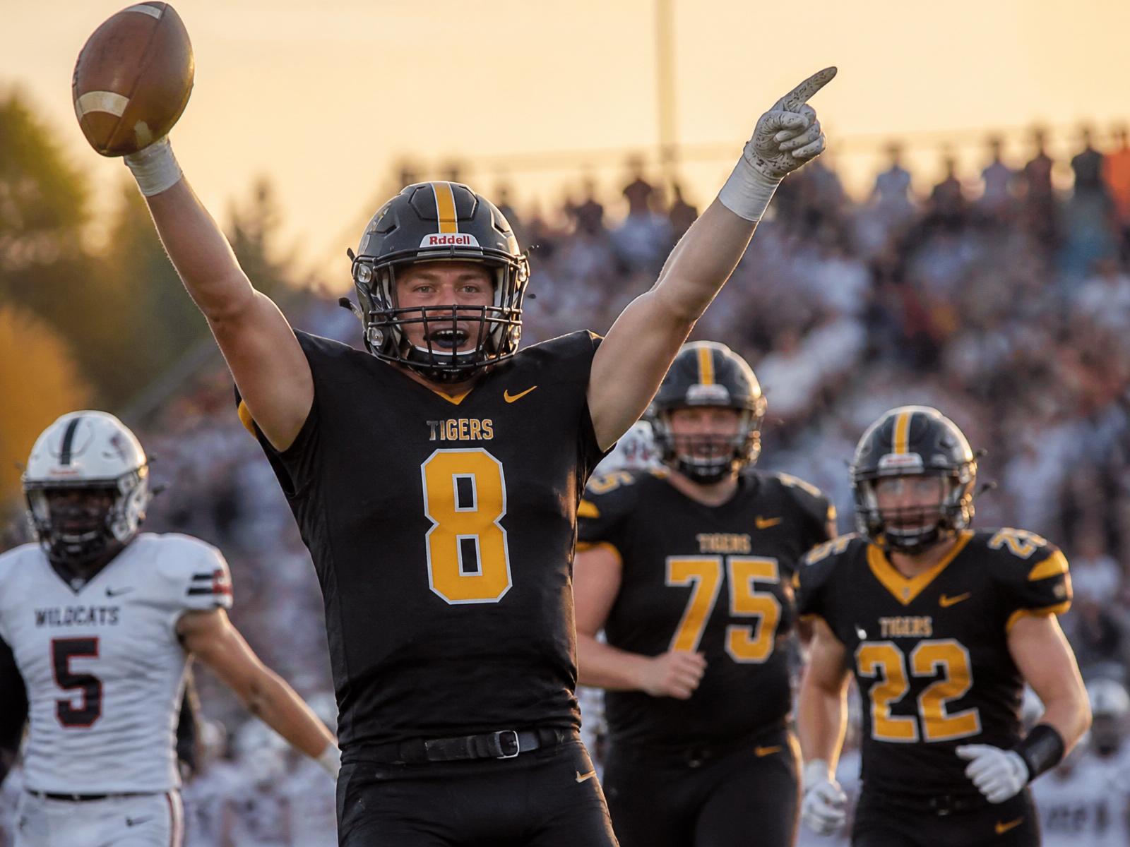 Student athletes celebrating on the field at a high school game